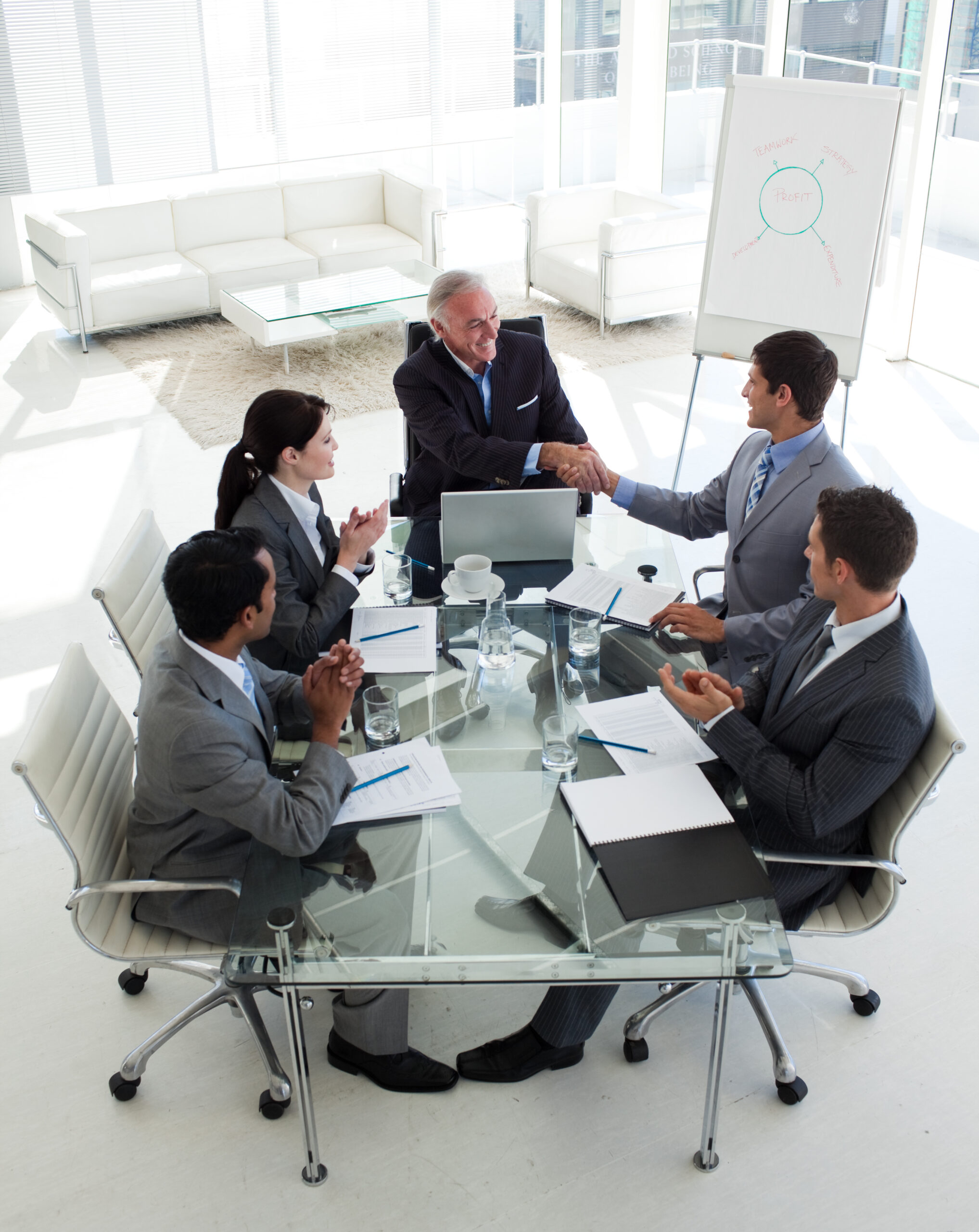 Happy businessman closing a deal at the end on a meeting